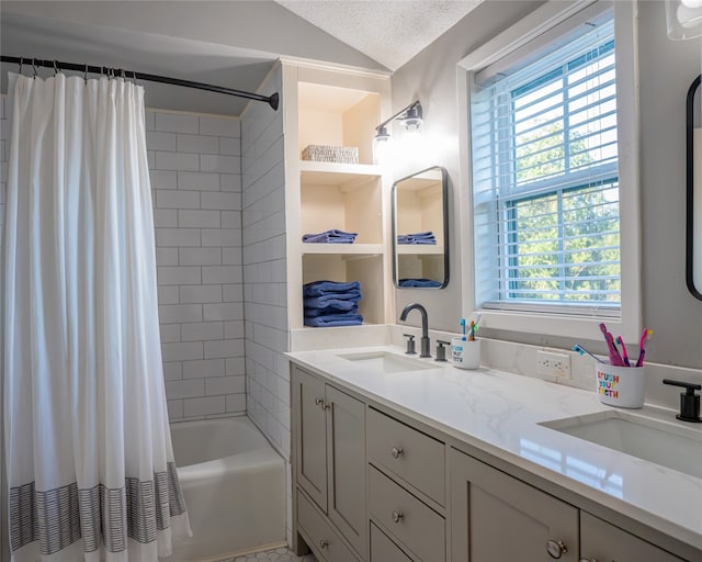 bathroom with vanity, lofted ceiling, shower / bath combo, and a textured ceiling