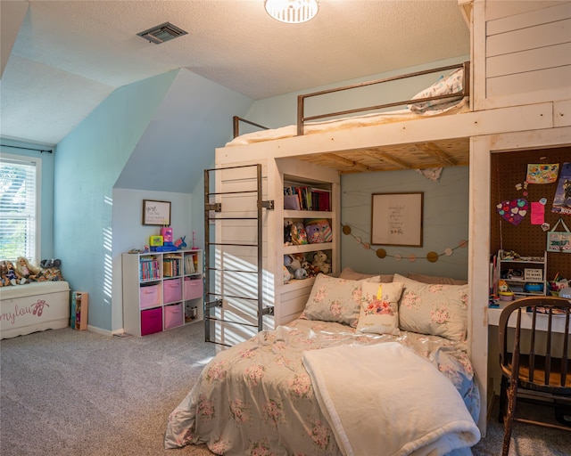 carpeted bedroom featuring lofted ceiling and a textured ceiling