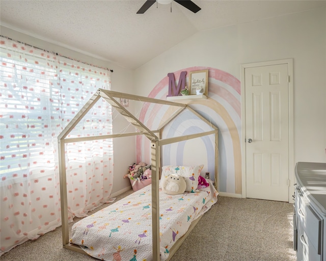 carpeted bedroom with a textured ceiling, ceiling fan, and vaulted ceiling