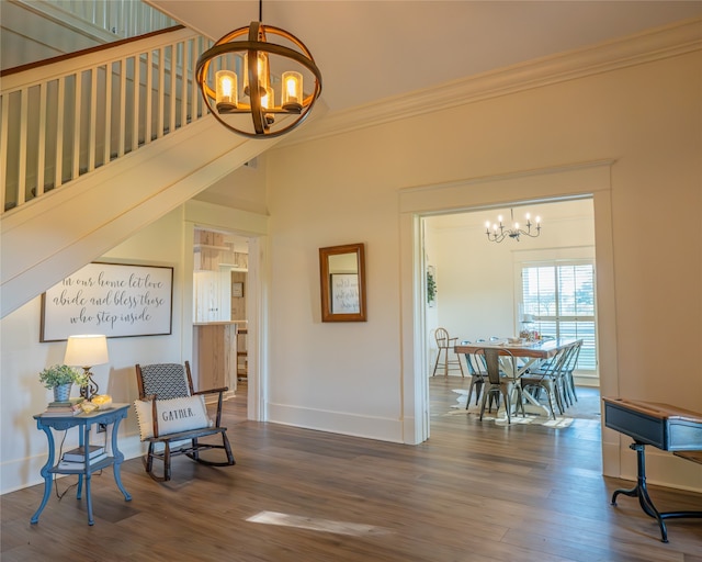 sitting room with crown molding, dark hardwood / wood-style flooring, and a notable chandelier