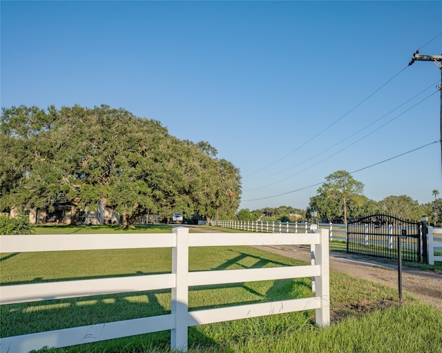 view of gate with a lawn