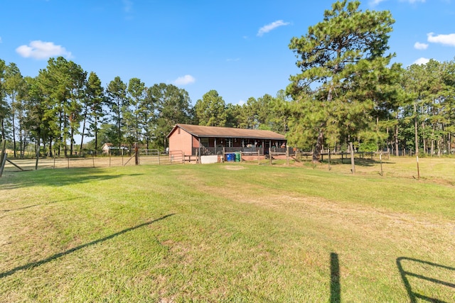 view of yard with a rural view and an outdoor structure