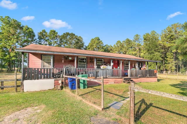 ranch-style home featuring a front yard and a porch