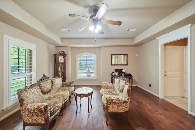 sitting room with wood-type flooring, ceiling fan, and plenty of natural light