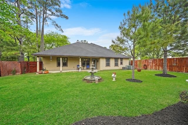 back of house with a lawn and central air condition unit