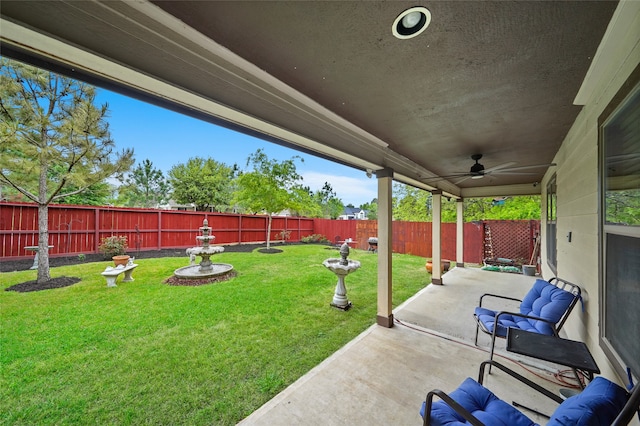 view of yard featuring ceiling fan and a patio area