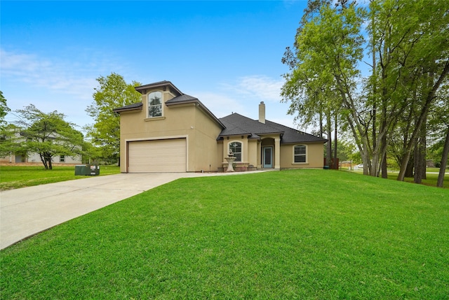 view of front of house with a garage and a front yard