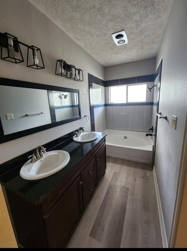 bathroom featuring a textured ceiling, vanity, and hardwood / wood-style floors