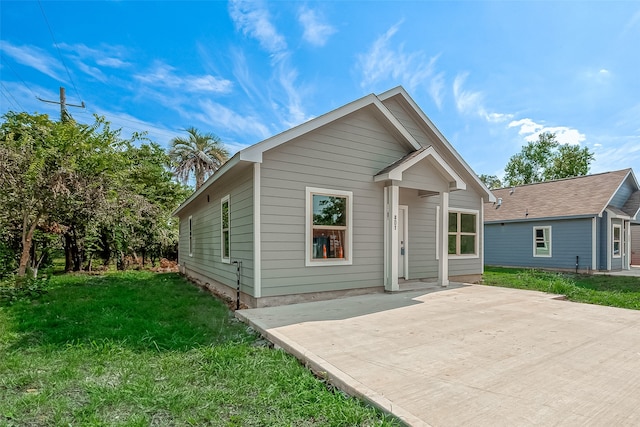 view of front facade featuring a front lawn and a patio area