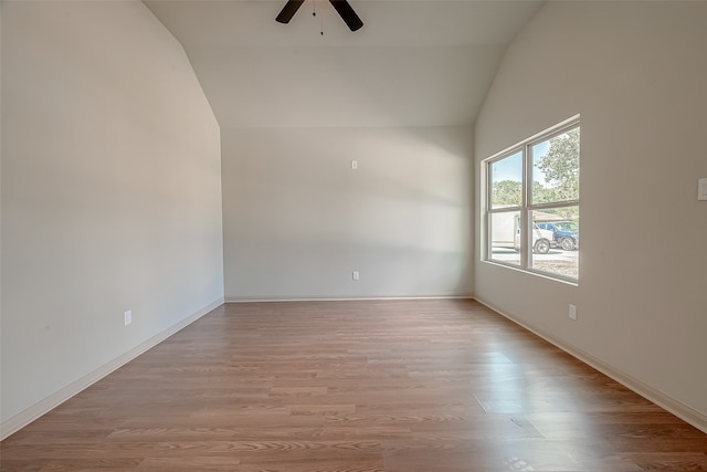 unfurnished room featuring light wood-type flooring, vaulted ceiling, and ceiling fan