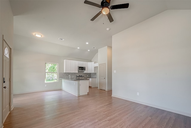 unfurnished living room with high vaulted ceiling, sink, ceiling fan, and light hardwood / wood-style flooring