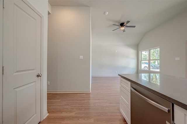 kitchen with dishwasher, light hardwood / wood-style floors, vaulted ceiling, white cabinetry, and ceiling fan