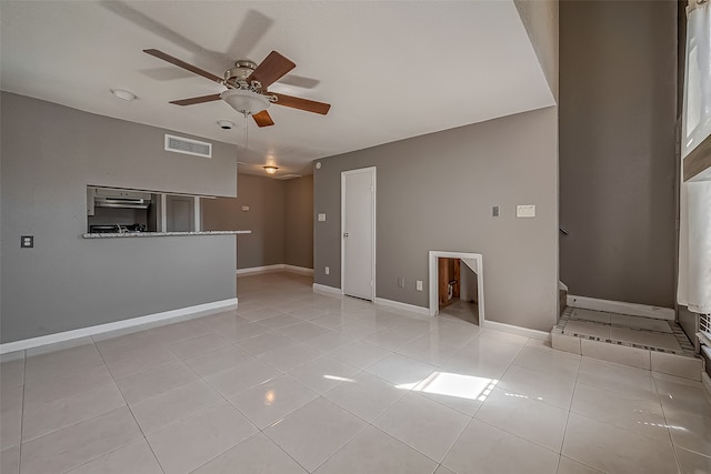 unfurnished living room with ceiling fan and light tile patterned flooring