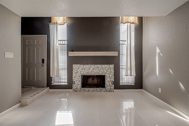 unfurnished living room featuring a tiled fireplace and light tile patterned floors