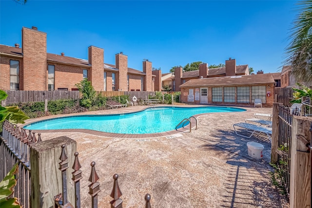 view of swimming pool with a patio