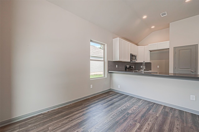 kitchen with white cabinets, sink, dark hardwood / wood-style floors, and vaulted ceiling