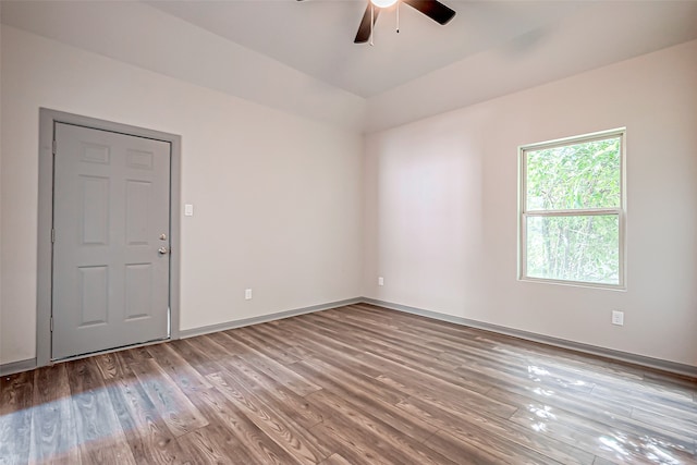 empty room with ceiling fan and hardwood / wood-style floors