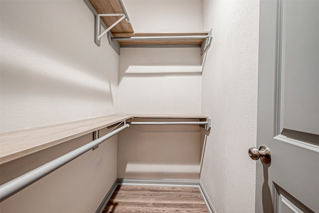 spacious closet with light hardwood / wood-style floors