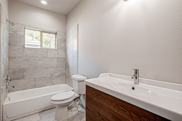 full bathroom with tiled shower / bath, vanity, toilet, and tile patterned floors