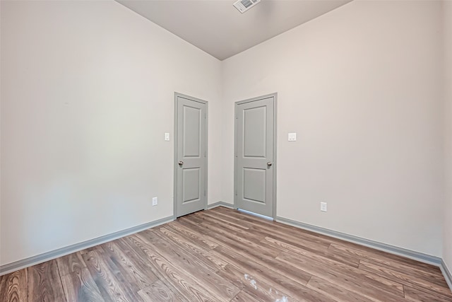 unfurnished room with light hardwood / wood-style floors