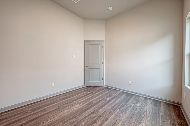 spare room with dark hardwood / wood-style flooring