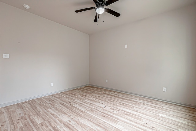 spare room featuring light hardwood / wood-style flooring and ceiling fan