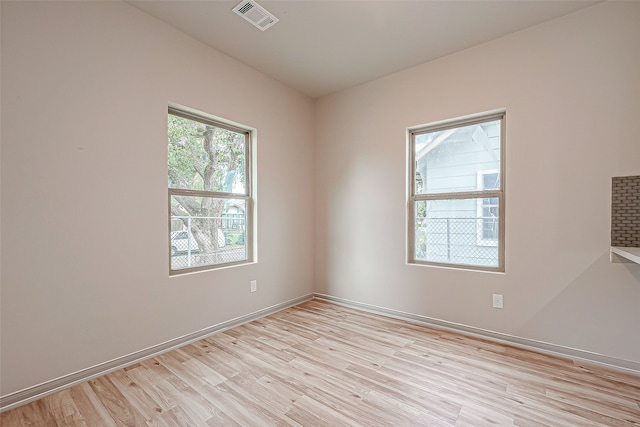 unfurnished room with light wood-type flooring