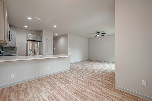 interior space with light hardwood / wood-style floors, sink, and ceiling fan