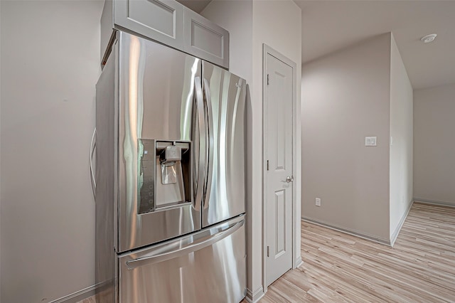 kitchen featuring light hardwood / wood-style flooring and stainless steel refrigerator with ice dispenser