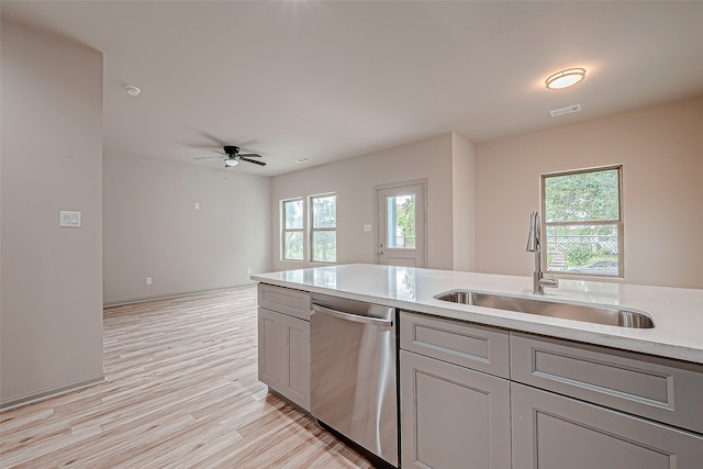 kitchen featuring gray cabinetry, ceiling fan, light hardwood / wood-style flooring, stainless steel dishwasher, and sink