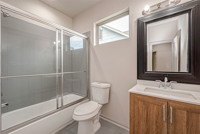 full bathroom featuring shower / bath combination with glass door, tile patterned flooring, vanity, and toilet