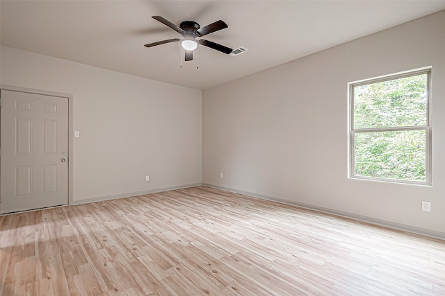 empty room with ceiling fan and light hardwood / wood-style floors