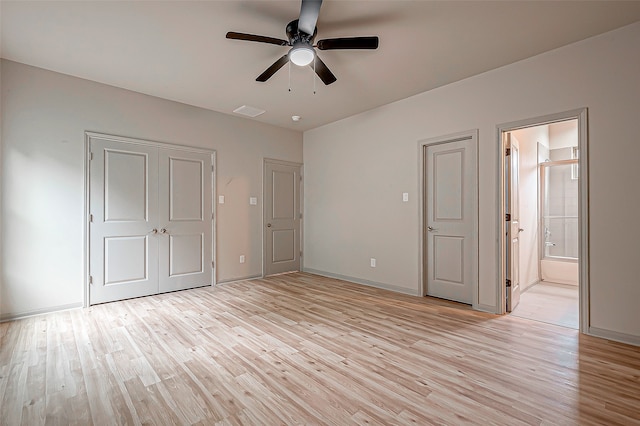 unfurnished bedroom with ensuite bath, ceiling fan, and light hardwood / wood-style floors