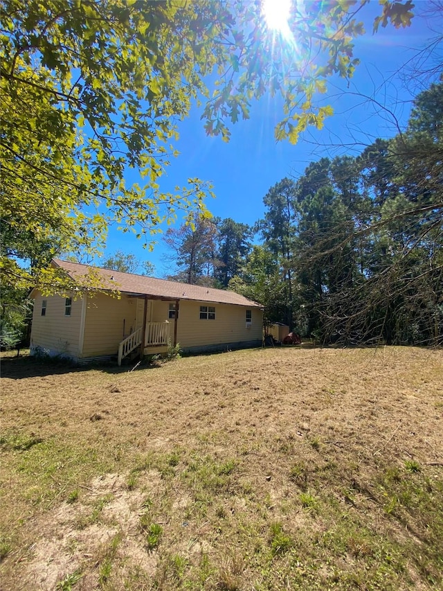 rear view of house featuring a lawn