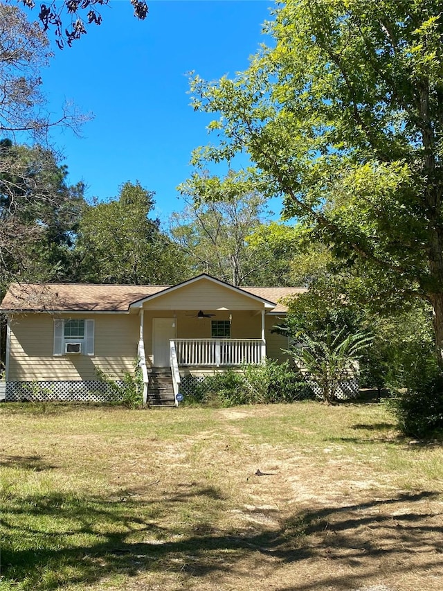 view of front of property with cooling unit, a porch, and a front yard