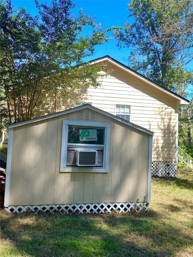 view of home's exterior with a shed and a yard