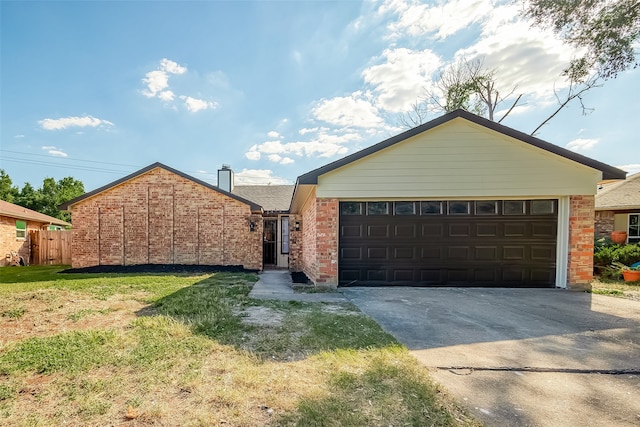 single story home featuring a front lawn and a garage