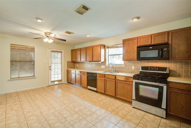 kitchen featuring ceiling fan, light tile patterned floors, sink, black appliances, and decorative backsplash