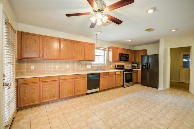 kitchen featuring ceiling fan, sink, light tile patterned floors, black appliances, and decorative backsplash