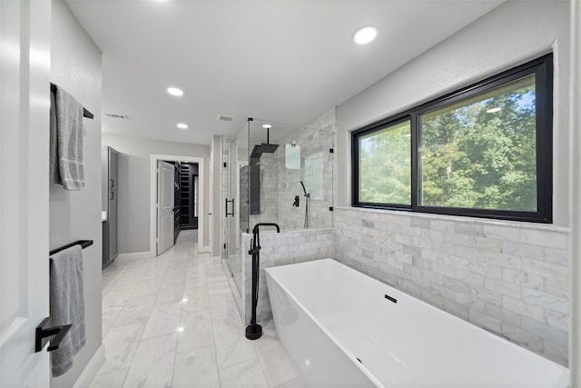 bathroom with shower with separate bathtub