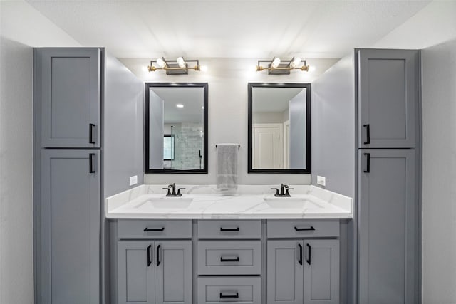 bathroom featuring a shower and vanity