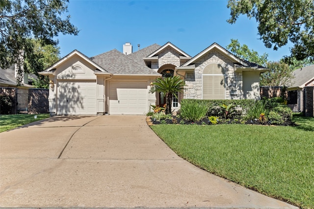 ranch-style house with a shingled roof, a front yard, a garage, stone siding, and driveway