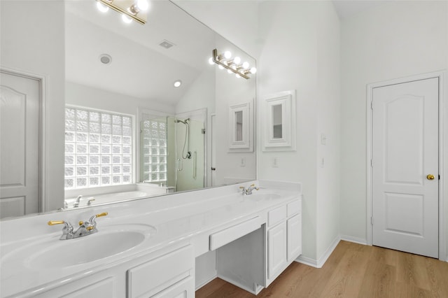 full bath featuring a stall shower, visible vents, lofted ceiling, wood finished floors, and a sink