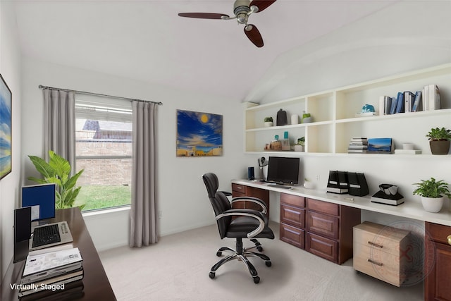 home office with light carpet, baseboards, a ceiling fan, built in study area, and lofted ceiling