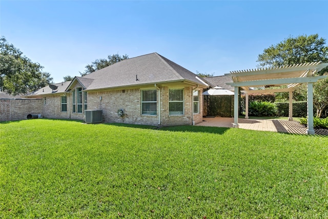 back of property with central AC, brick siding, a yard, a pergola, and a patio area