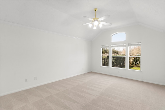 spare room featuring light carpet, ceiling fan, lofted ceiling, and baseboards