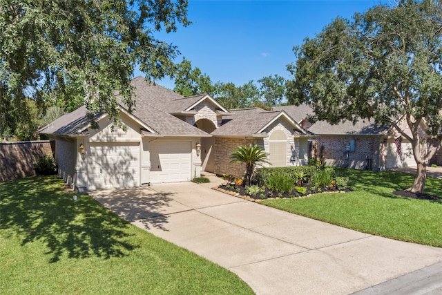 single story home with driveway, a front lawn, an attached garage, and stone siding