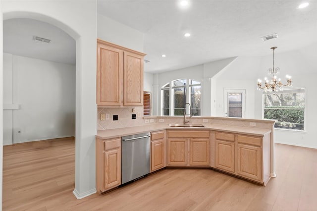 kitchen featuring visible vents, dishwasher, light countertops, light brown cabinets, and a sink