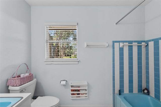 full bathroom with toilet, tiled shower / bath, and sink