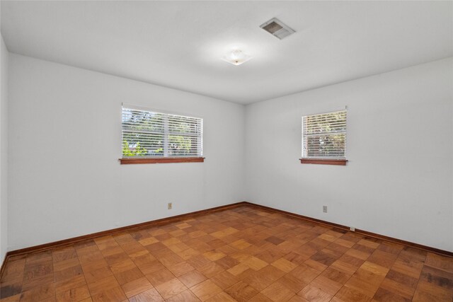 unfurnished room featuring plenty of natural light